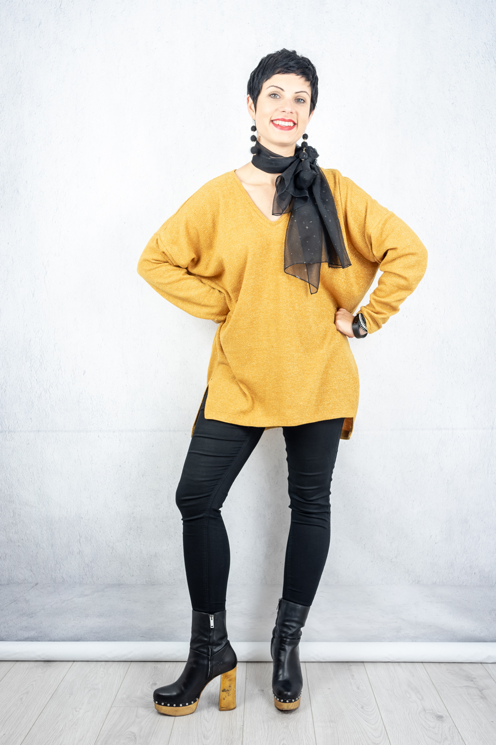 Oversized saffron jumper with metallic thread paired with skinny jeans, wooden platforms and a black scarf